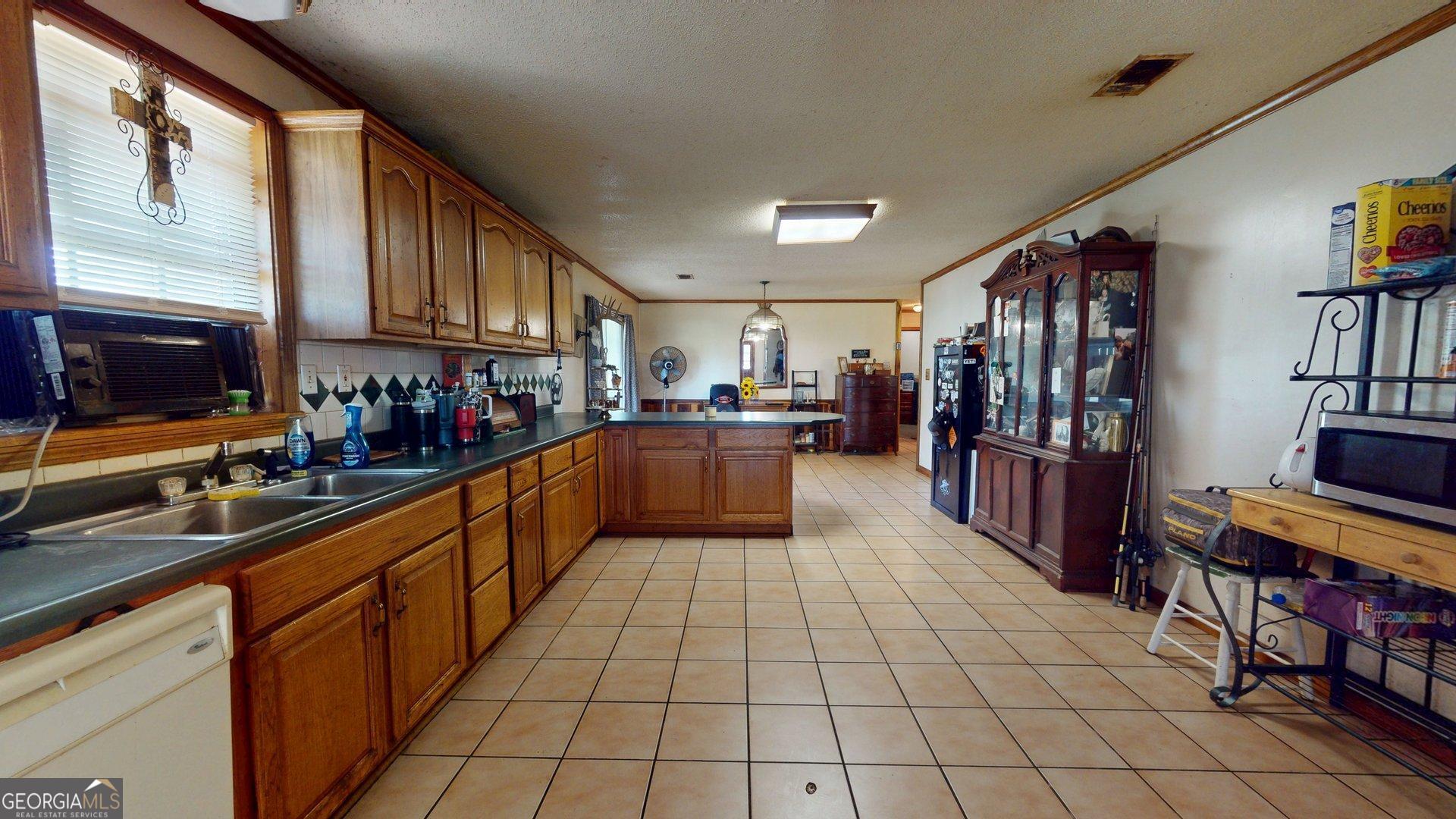 450 Bellevue Plantation Road Millen, GA 30442 - Photo 9 of 25 a kitchen with stainless steel appliances lots of counter top space