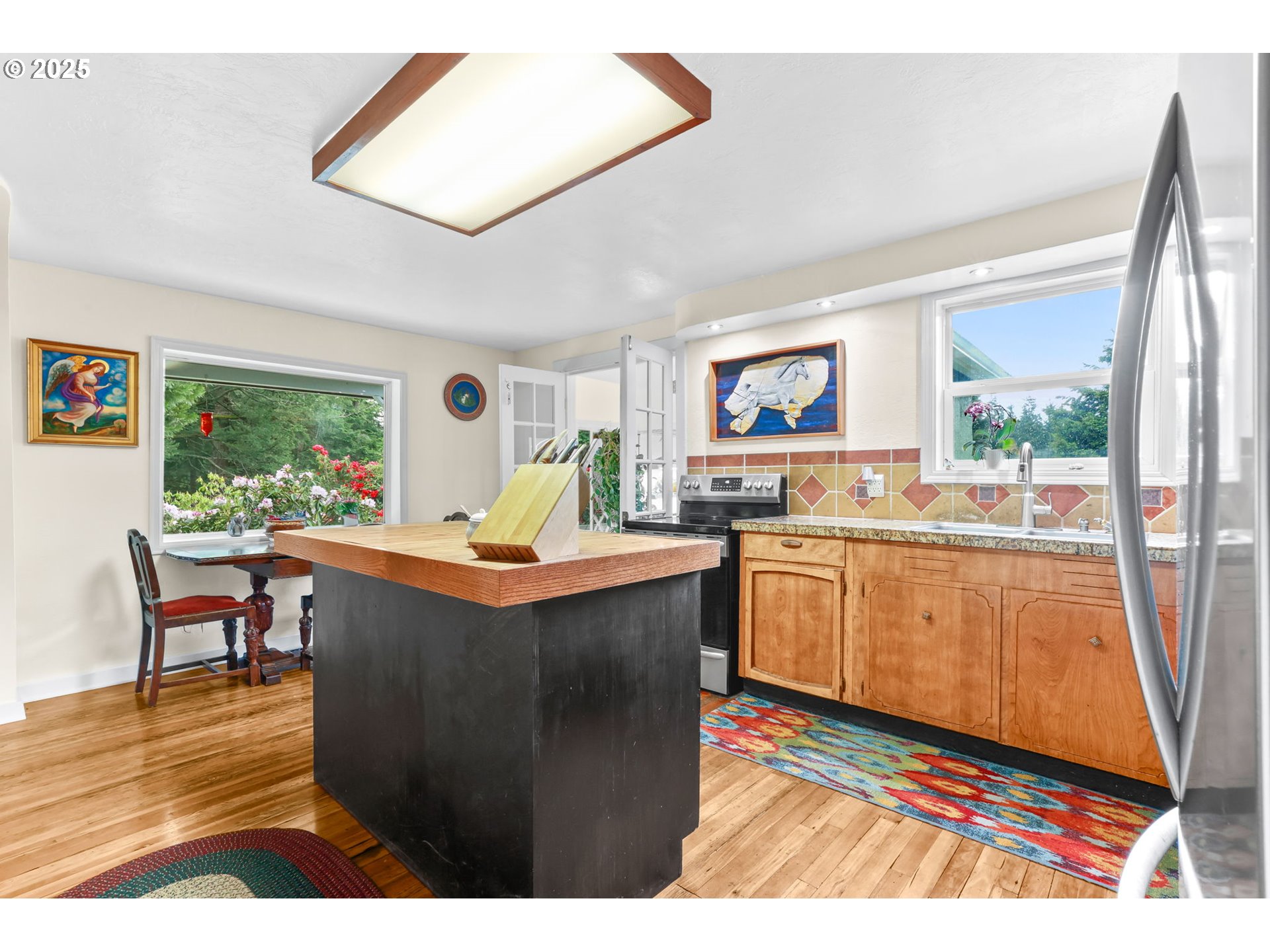 26011 South Morgan Road Estacada, OR 97023 - Photo 6 of 48 a living room with kitchen island furniture a rug kitchen view and a large window