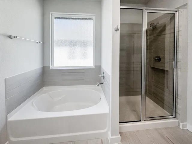 a white bath tub sitting next to a shower
