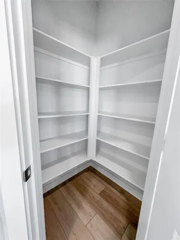 a view of walk in closet with empty racks
