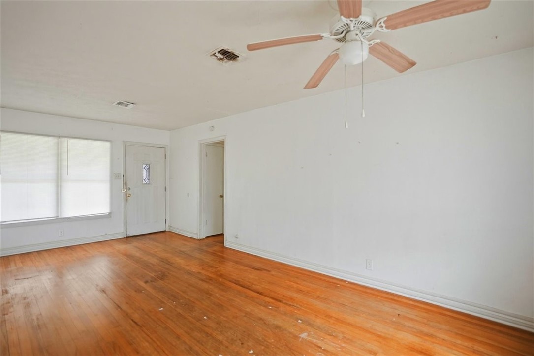 3633 Chestnut Street Corpus Christi, TX 78411 - Photo 11 of 22 an empty room with wooden floor fan and windows