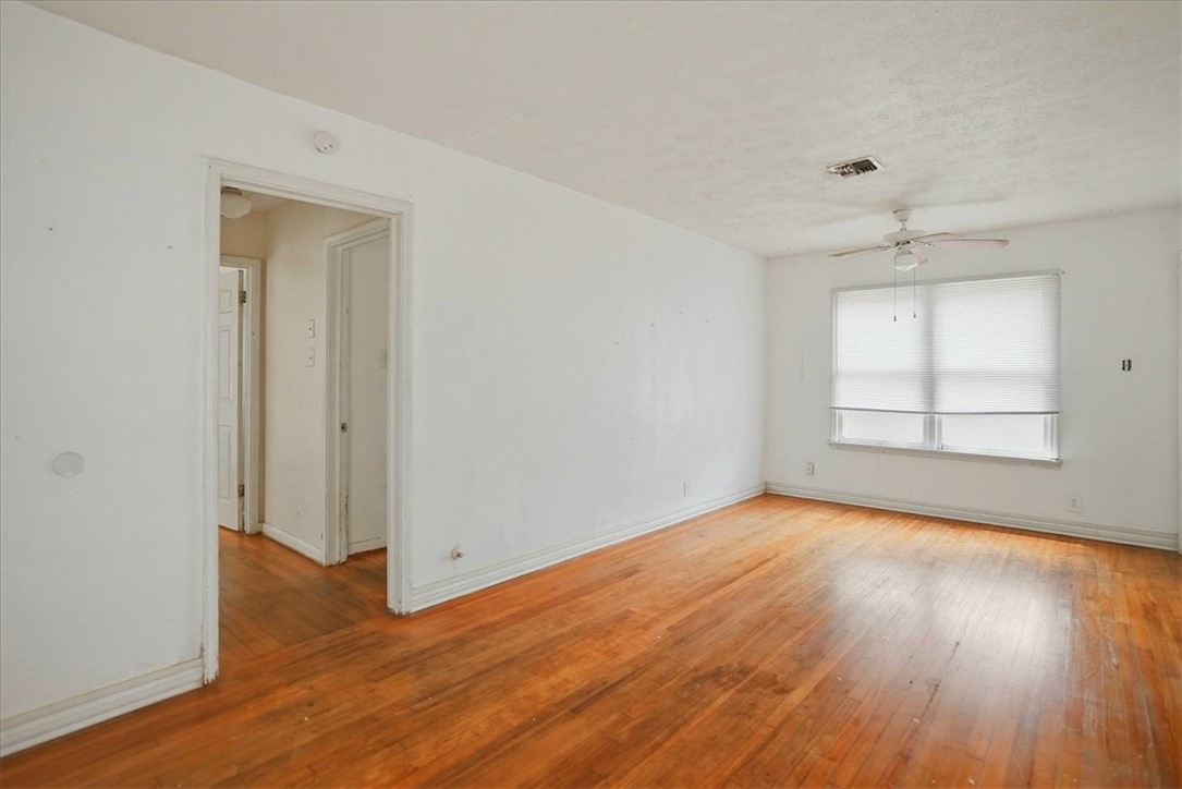 3633 Chestnut Street Corpus Christi, TX 78411 - Photo 12 of 22 an empty room with wooden floor and windows