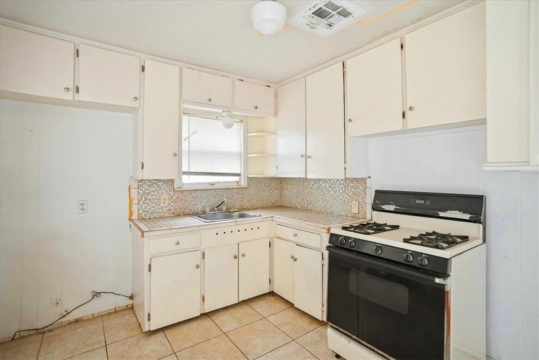3633 Chestnut Street Corpus Christi, TX 78411 - Photo 13 of 22 a kitchen with granite countertop white cabinets and white appliances
