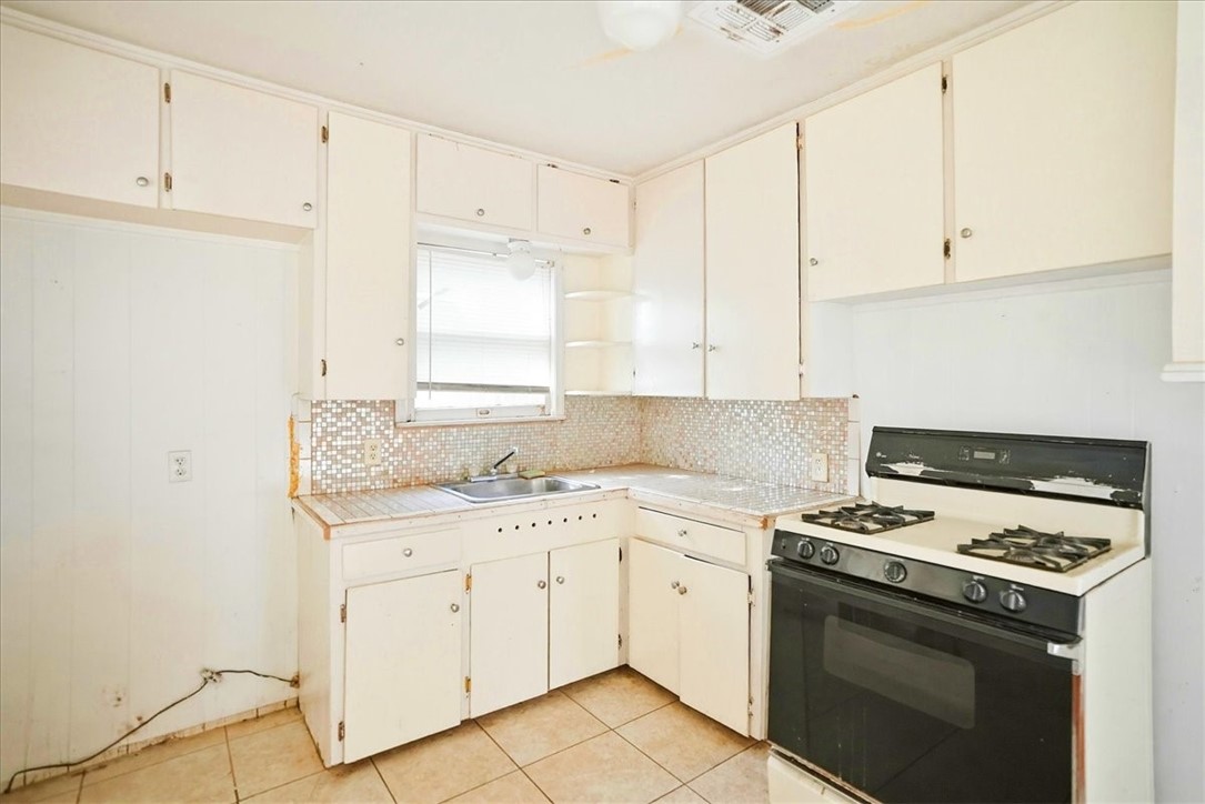 3633 Chestnut Street Corpus Christi, TX 78411 - Photo 15 of 22 a kitchen with granite countertop white cabinets and white appliances