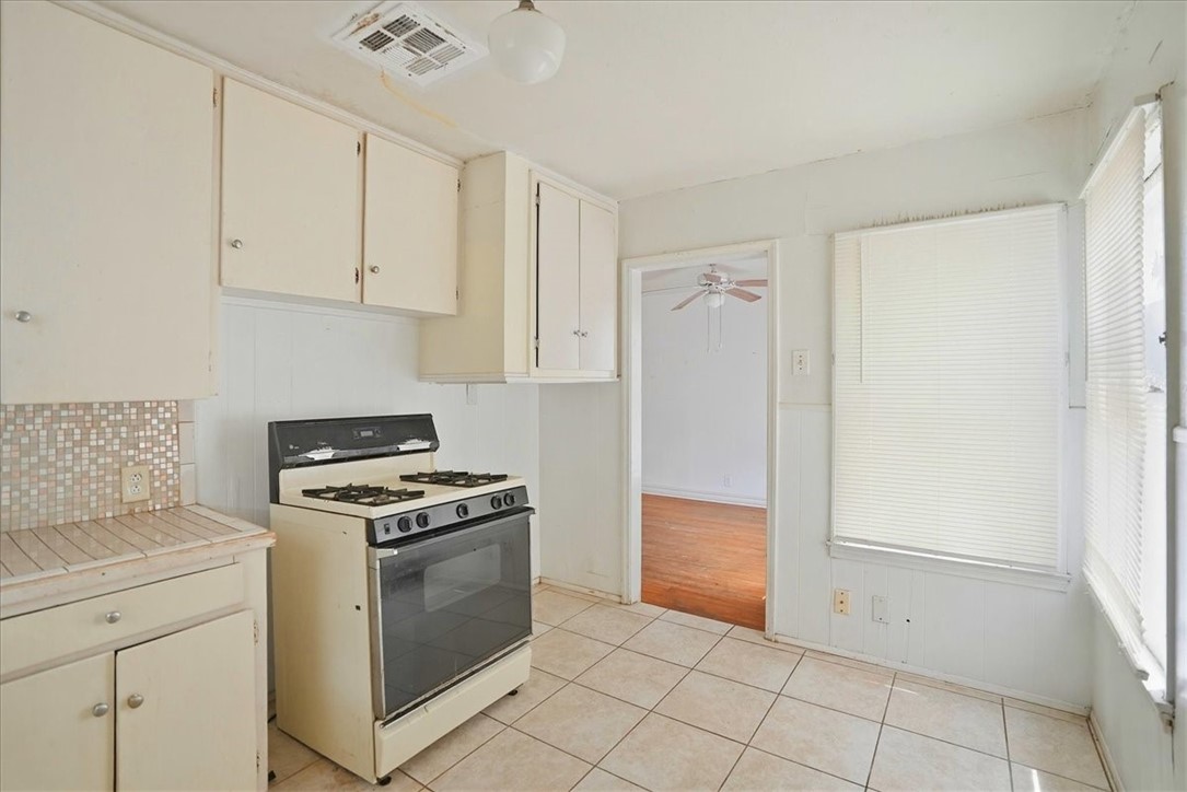3633 Chestnut Street Corpus Christi, TX 78411 - Photo 21 of 22 a kitchen with white cabinets and white appliances