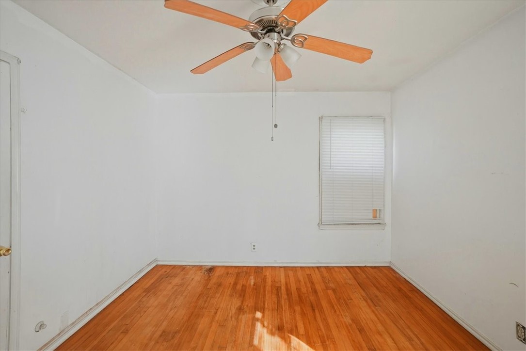 3633 Chestnut Street Corpus Christi, TX 78411 - Photo 10 of 22 a view of a room with wooden floor and a ceiling fan