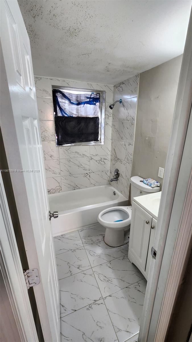 1761 Ali Baba Avenue, Unit 1 Opa-Locka, FL 33054 - Photo 6 of 10 a bathroom with a toilet and a shower