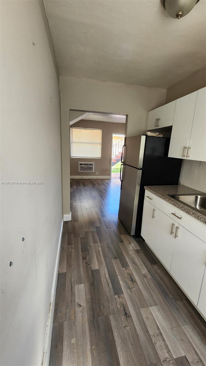 1761 Ali Baba Avenue, Unit 1 Opa-Locka, FL 33054 - Photo 9 of 10 a view of a kitchen with wooden floor and electronic appliances