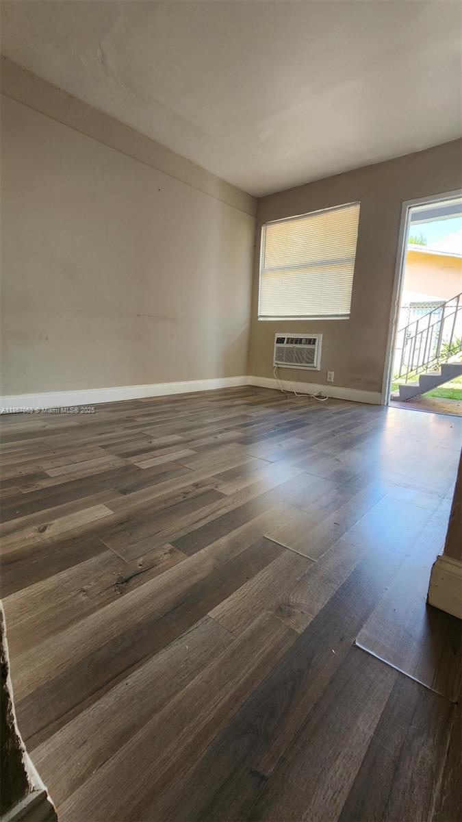 1761 Ali Baba Avenue, Unit 1 Opa-Locka, FL 33054 - Photo 10 of 10 an empty room with wooden floor and windows