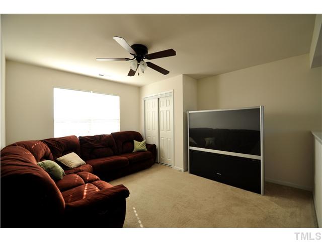 1421 Springshire Court Raleigh, NC 27610 - Photo 7 of 8 a living room with furniture and a flat screen tv