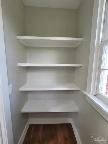 a view of walk in closet with empty racks
