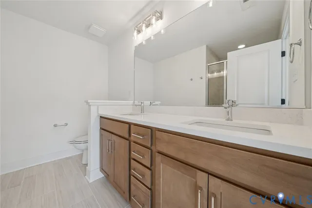 a bathroom with a double vanity sink and a mirror