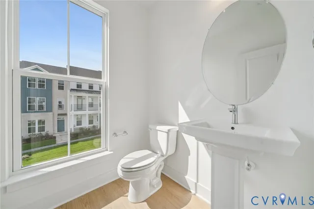 a bathroom with a toilet a sink and a mirror