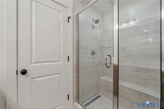 a bathroom with a glass shower door