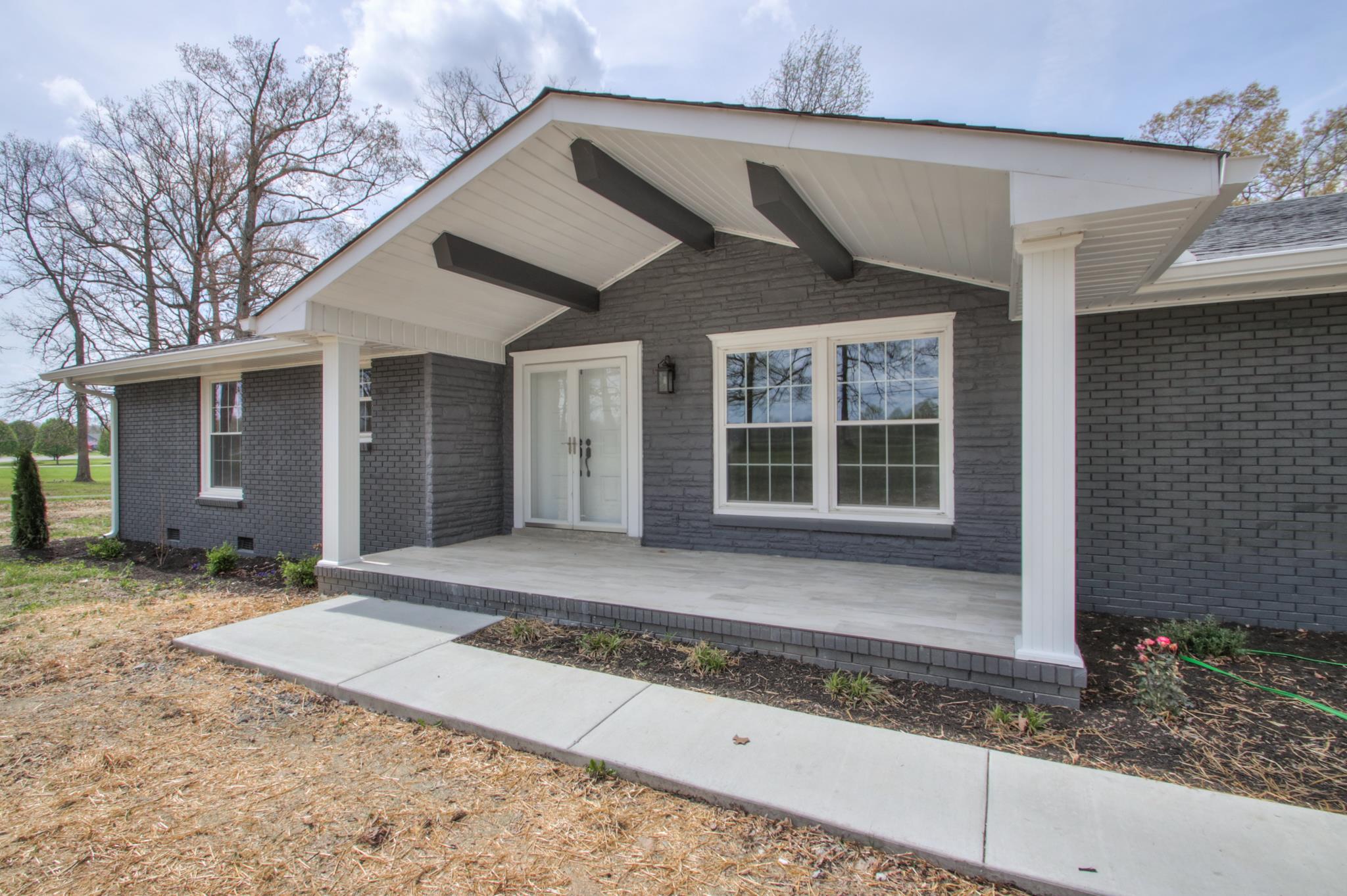 2964 Logan Road Greenbrier, TN 37073 - Photo 2 of 28 a front view of a house with a yard and garage