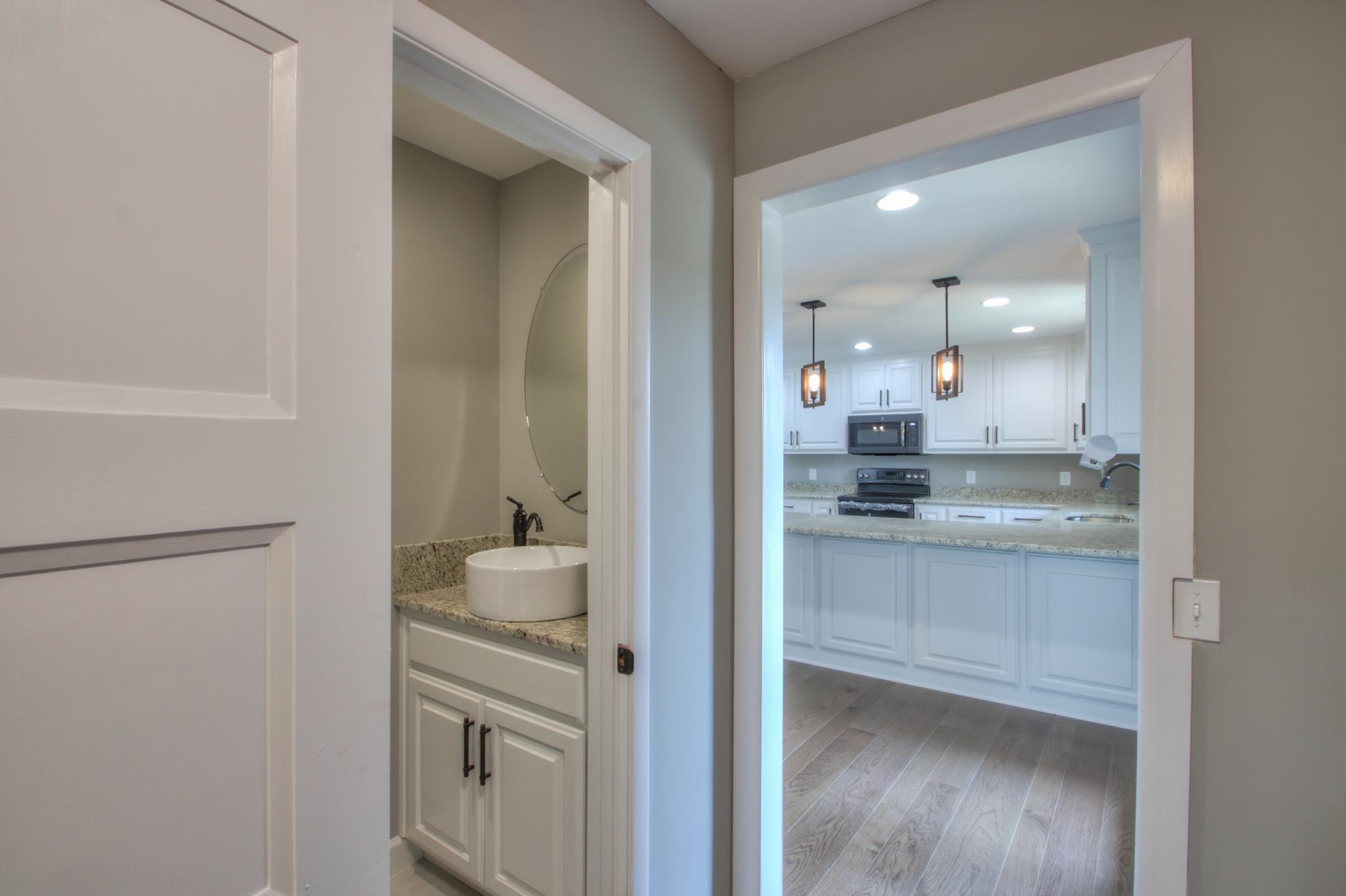 2964 Logan Road Greenbrier, TN 37073 - Photo 12 of 28 a bathroom with a granite countertop sink mirror and vanity