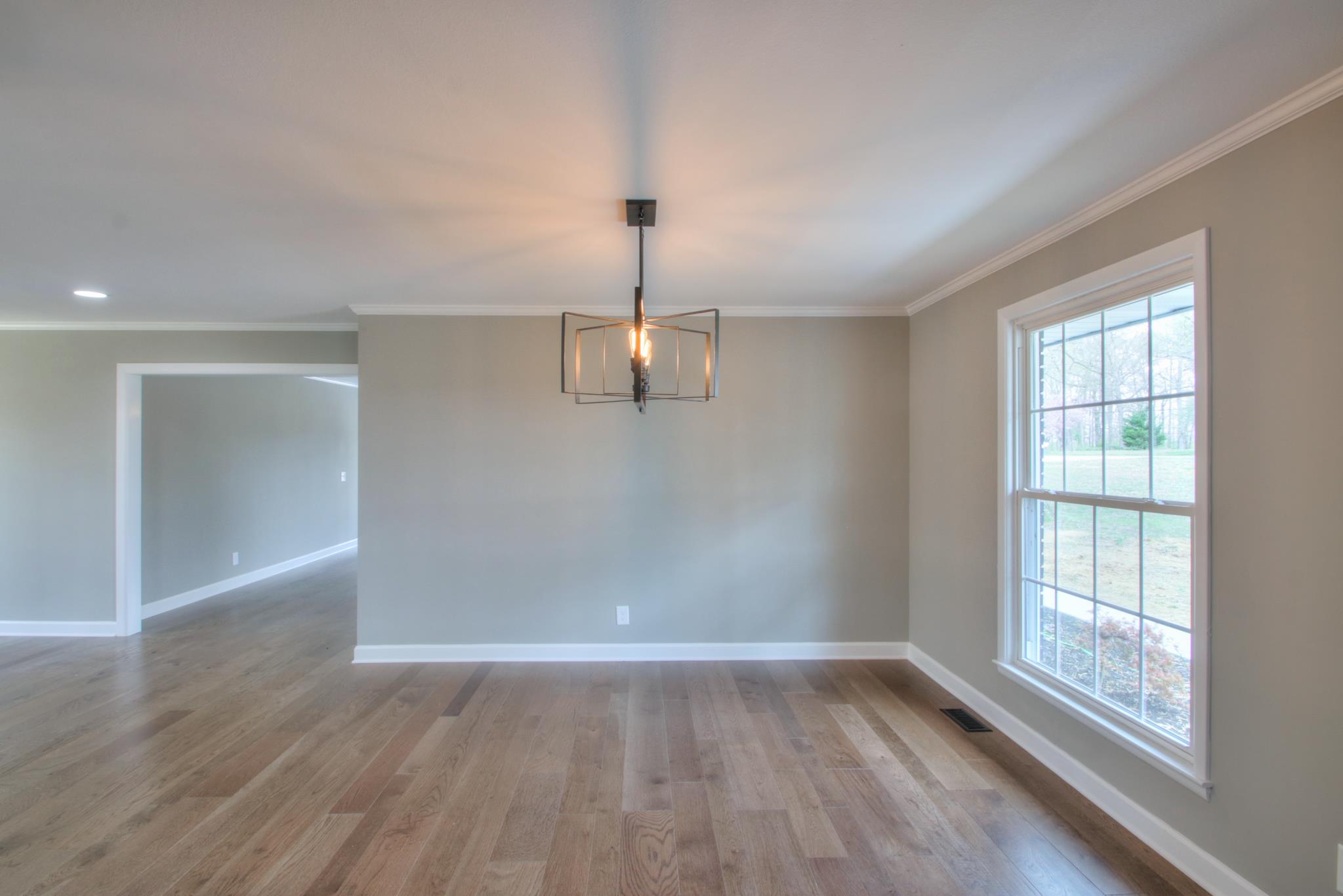 2964 Logan Road Greenbrier, TN 37073 - Photo 13 of 28 an empty room with wooden floor cabinet and windows