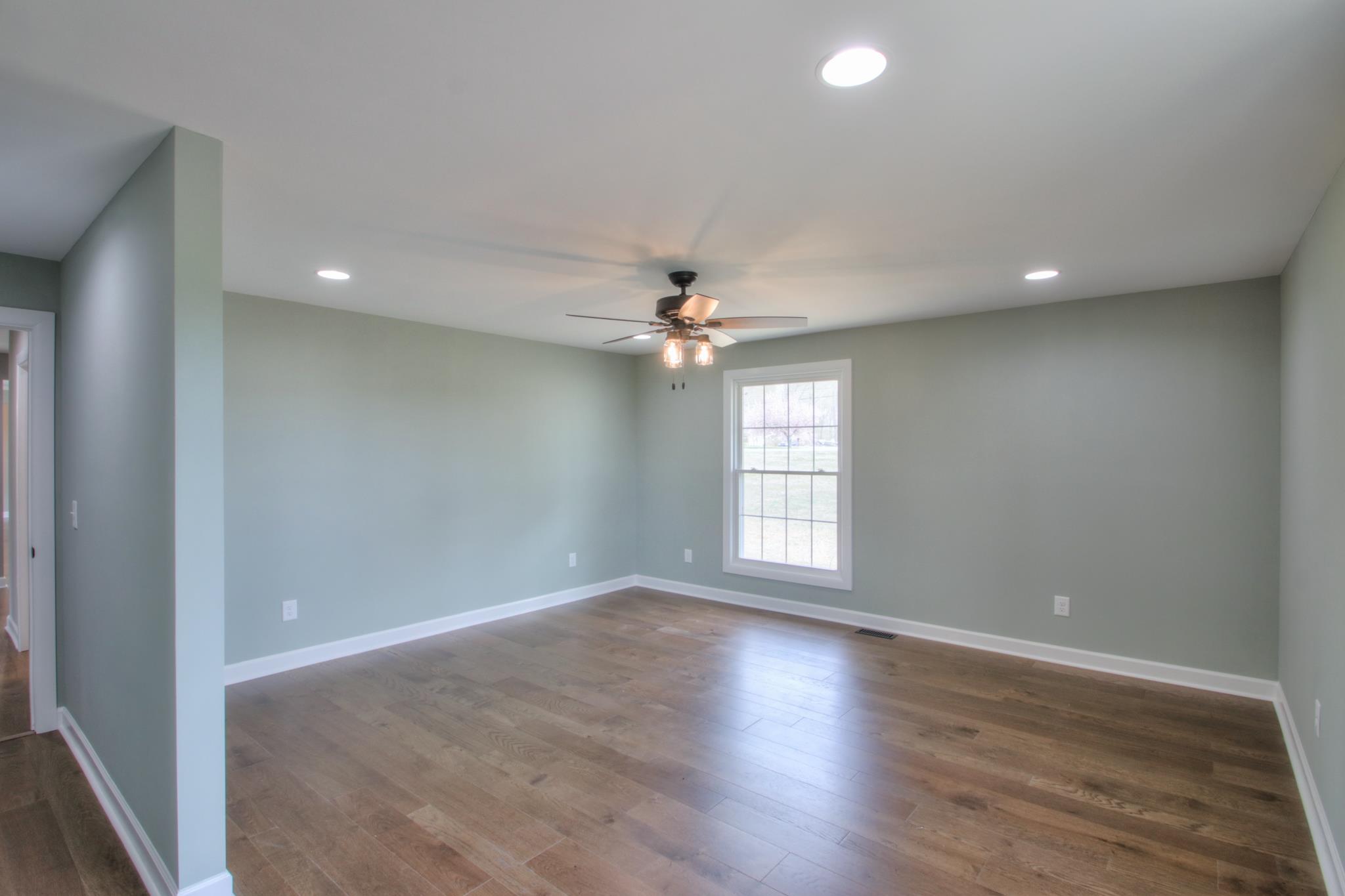 2964 Logan Road Greenbrier, TN 37073 - Photo 18 of 28 wooden floor in an empty room with a window
