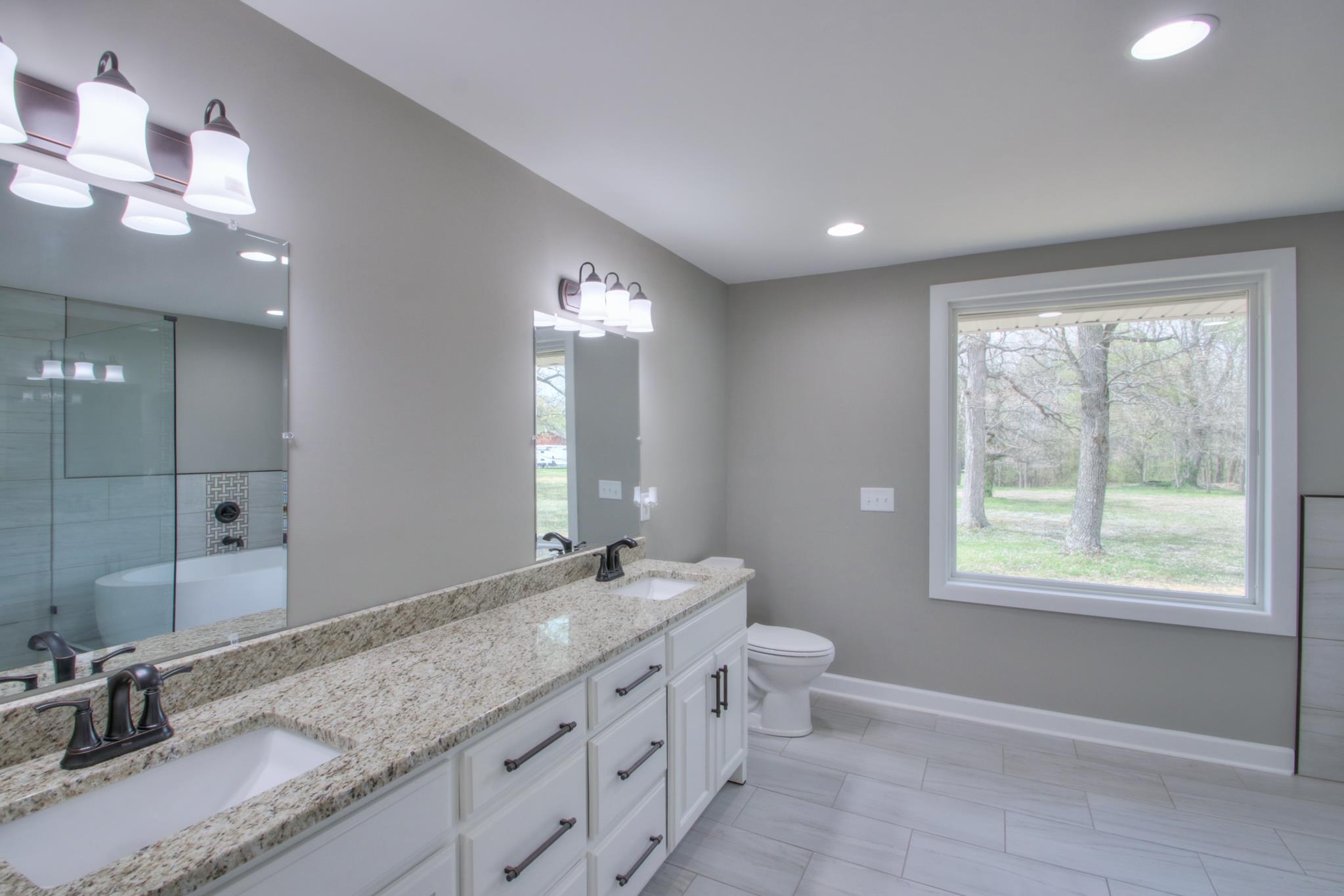 2964 Logan Road Greenbrier, TN 37073 - Photo 21 of 28 a bathroom with double vanity and a mirror