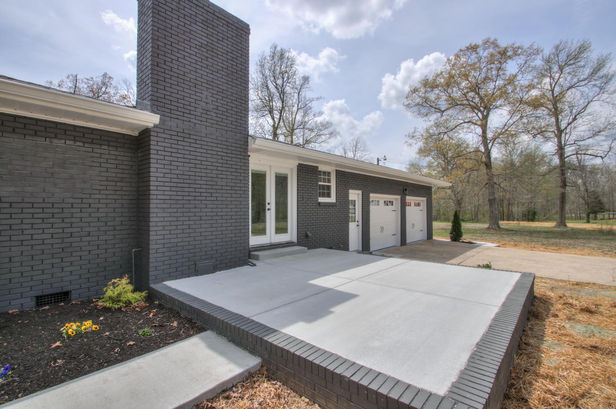 2964 Logan Road Greenbrier, TN 37073 - Photo 5 of 28 a front view of a house with a yard and garage