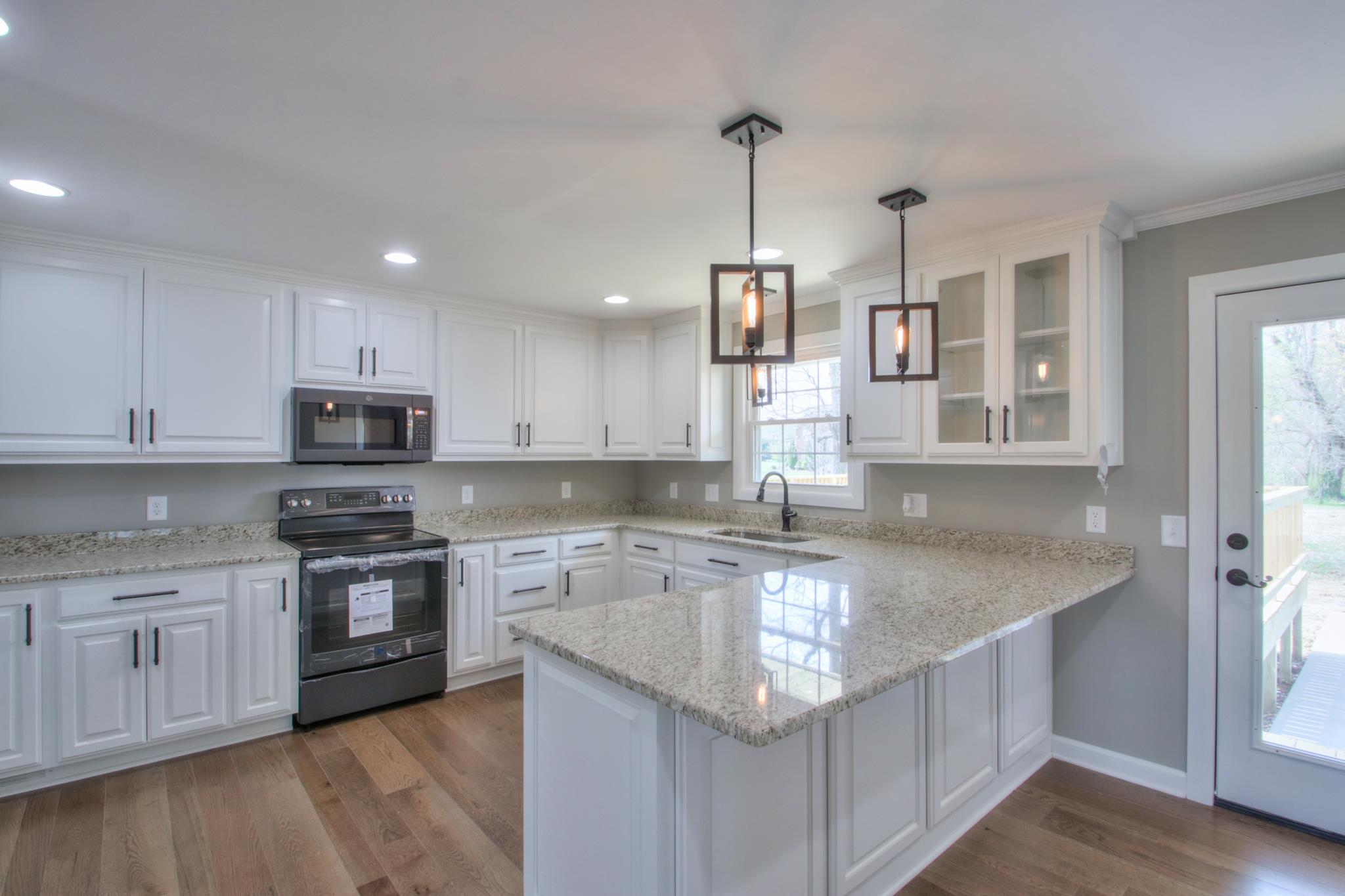 2964 Logan Road Greenbrier, TN 37073 - Photo 10 of 28 a kitchen with stainless steel appliances granite countertop a sink stove and refrigerator