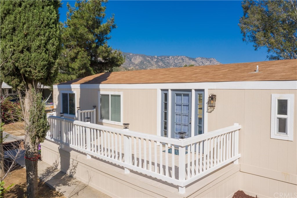 32785 Batson Lane Wildomar, CA 92595 - Photo 4 of 21 Beautiful deck in front with plenty of room for a bistro table to sit with a cup of joe while you await you family or friends to arrive.