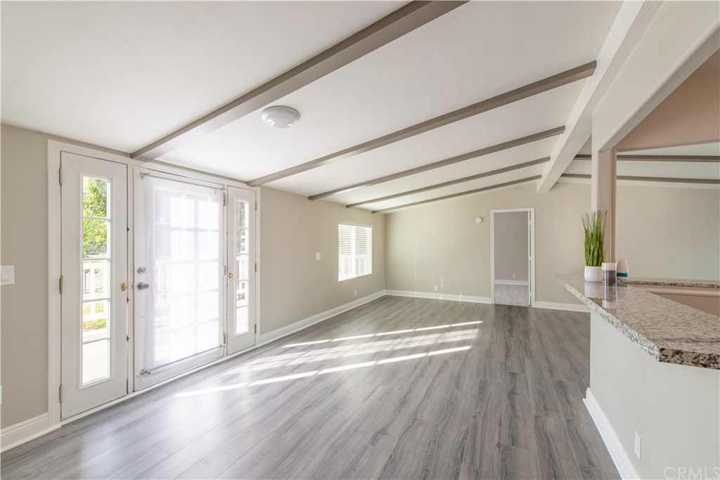 32785 Batson Lane Wildomar, CA 92595 - Photo 6 of 21 Looking back at the front door in this view. The door on the far wall is to the master bedroom. 2 more bedrooms are down the hallway behind where we are now standing. You can see a breakfast bar on the right which borders the open kitchen.