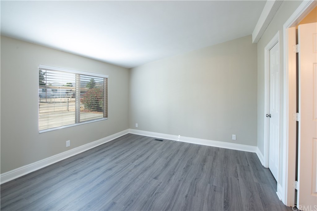 32785 Batson Lane Wildomar, CA 92595 - Photo 9 of 21 Master bedroom is located at the front of the home. It has a master bath (open door on the right) and a wlak-in closet (closed door on the right.