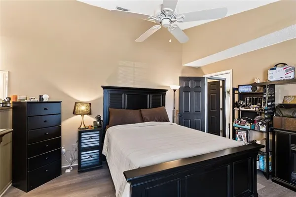 a bedroom with a bed and a bookshelf