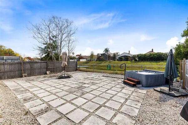 a view of a yard with wooden fence