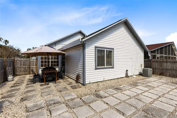 a view of house with backyard and sitting area