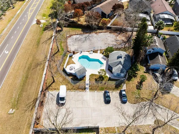 an aerial view of a house with a backyard