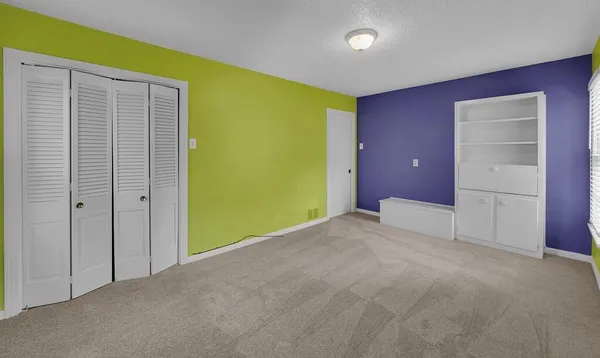 a view of an empty room with closet