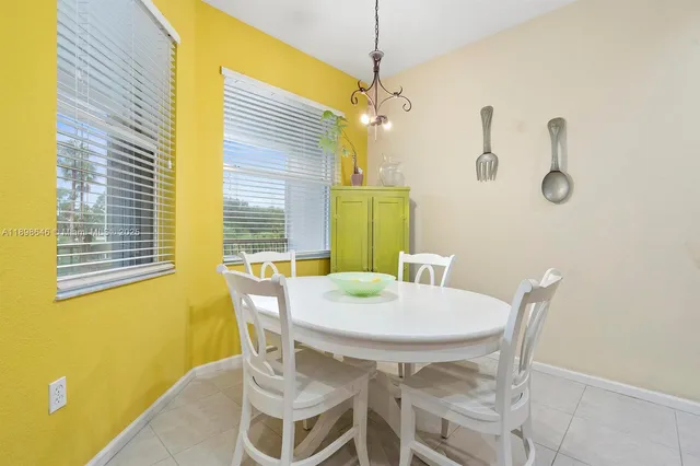 a view of a dining room with furniture and a window