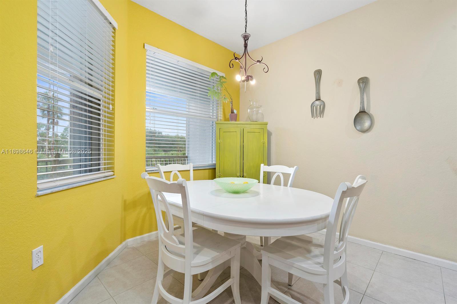 7550 Southwest Herrington Lane, Unit 7550 Stuart, FL 34997 - Photo 12 of 23 a view of a dining room with furniture and a window