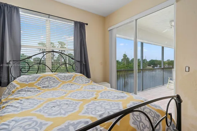 a bedroom with a bed and a large window