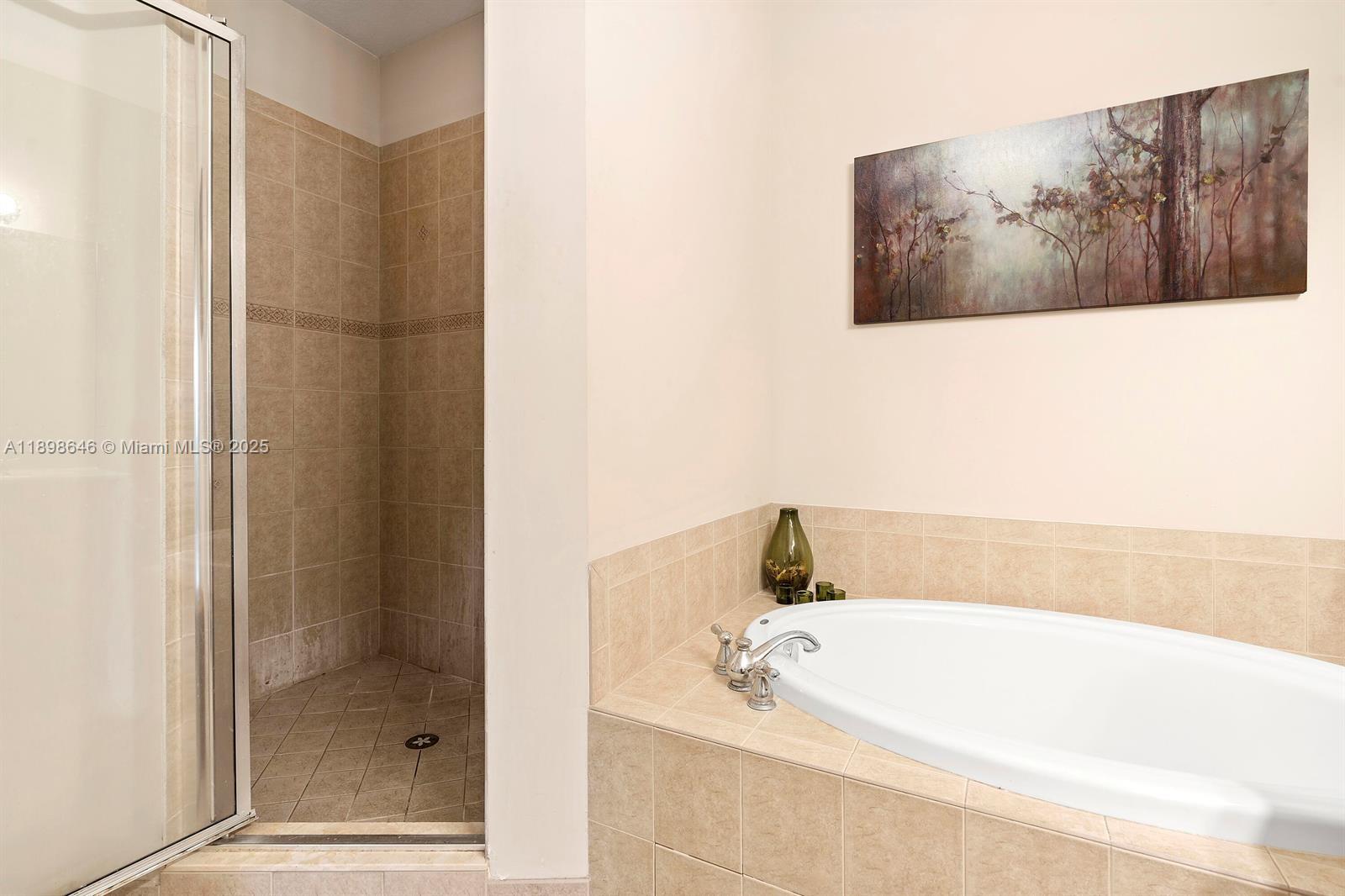 7550 Southwest Herrington Lane, Unit 7550 Stuart, FL 34997 - Photo 20 of 23 a bathroom with a tub and shower