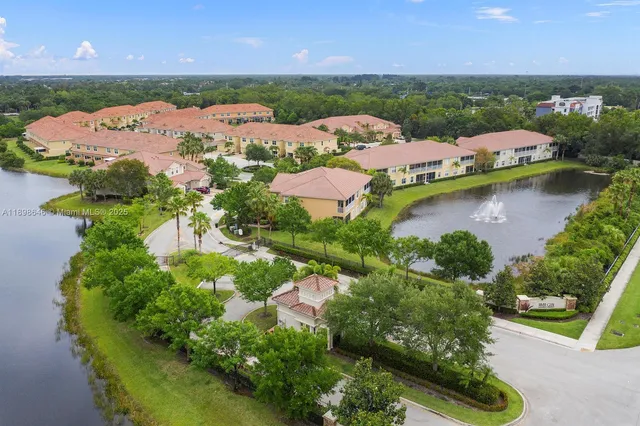 an aerial view of residential houses with outdoor space and river