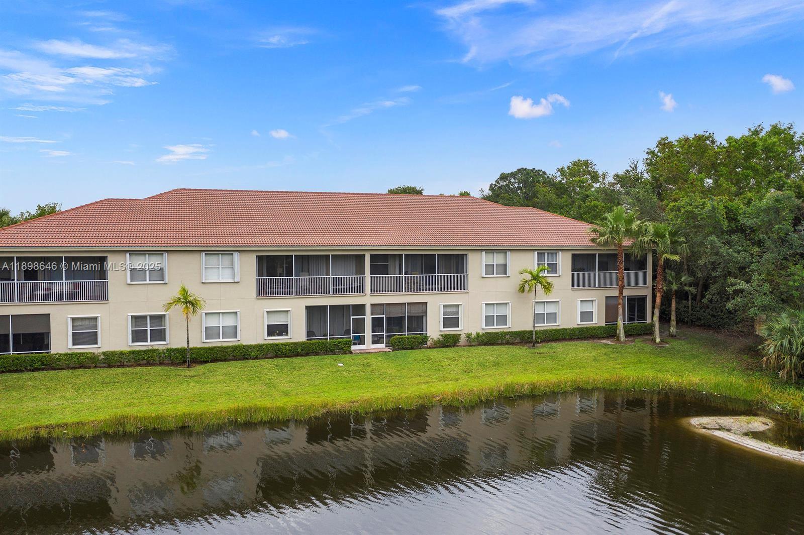 7550 Southwest Herrington Lane, Unit 7550 Stuart, FL 34997 - Photo 4 of 23 a view of a house with swimming pool and a yard
