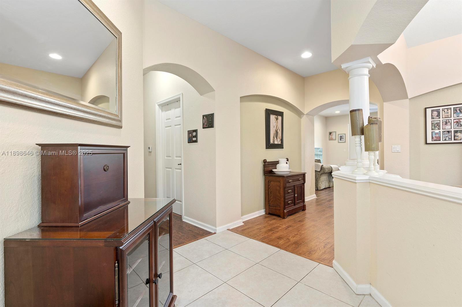 7550 Southwest Herrington Lane, Unit 7550 Stuart, FL 34997 - Photo 5 of 23 a living room with furniture and a flat screen tv
