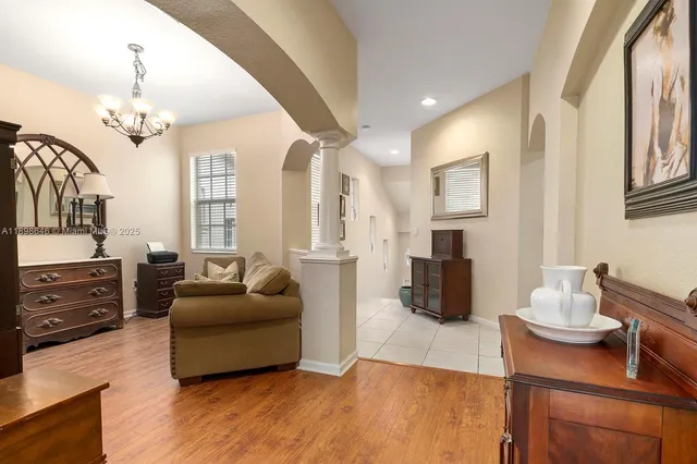a living room with furniture fireplace and wooden floor