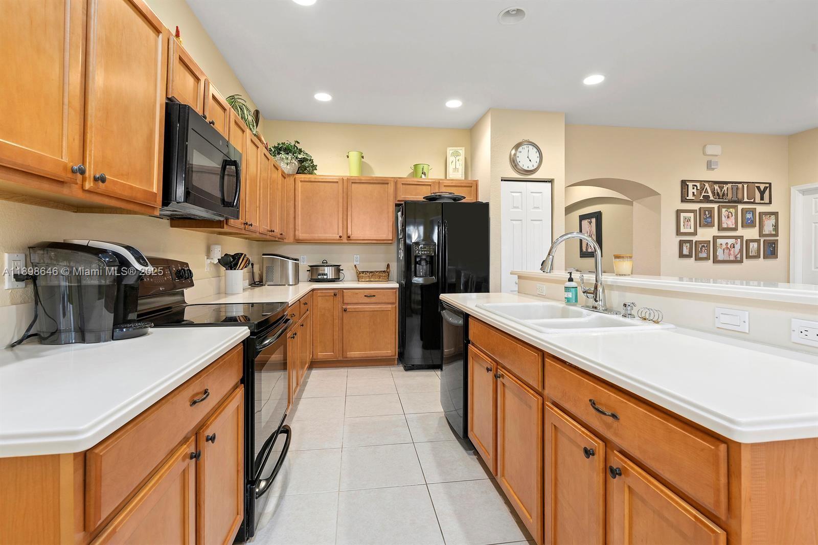 7550 Southwest Herrington Lane, Unit 7550 Stuart, FL 34997 - Photo 9 of 23 a kitchen with a sink stove and cabinets