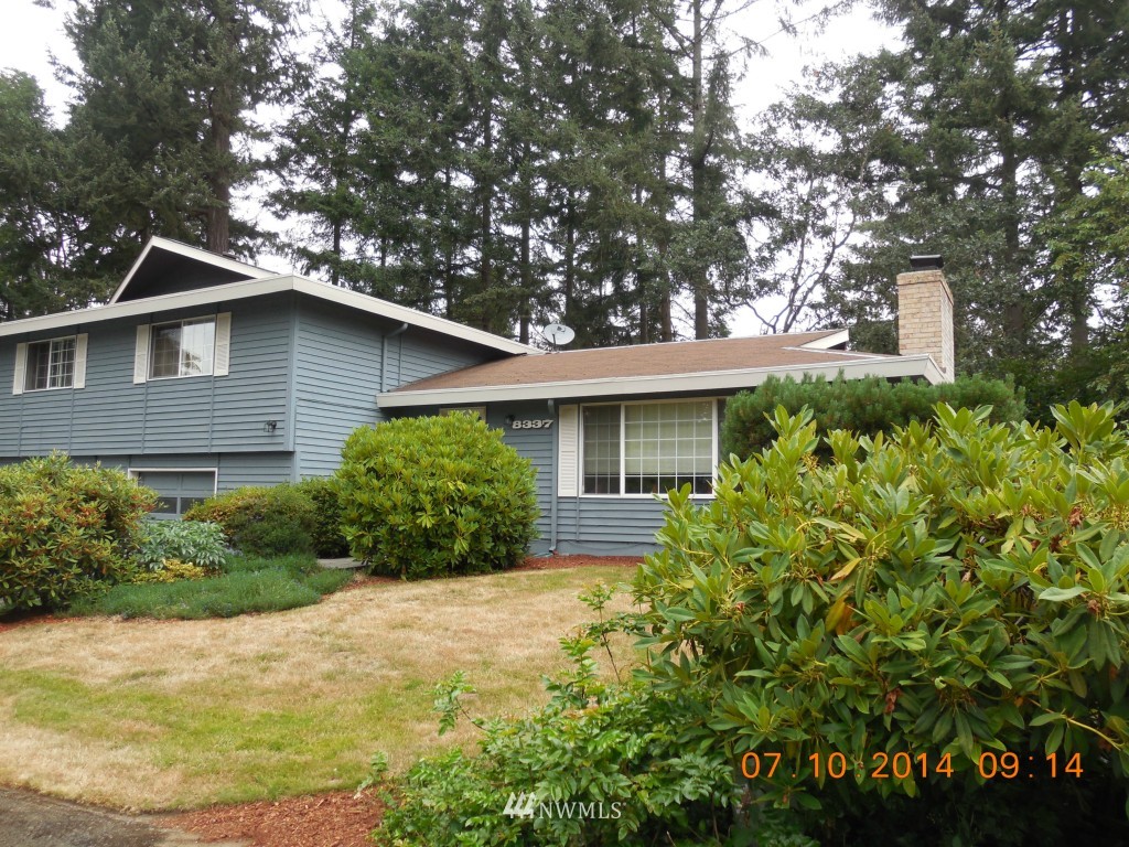 8327 Phillips Road Southwest Lakewood, WA 98498 - Photo 2 of 6 a front view of a house with garden