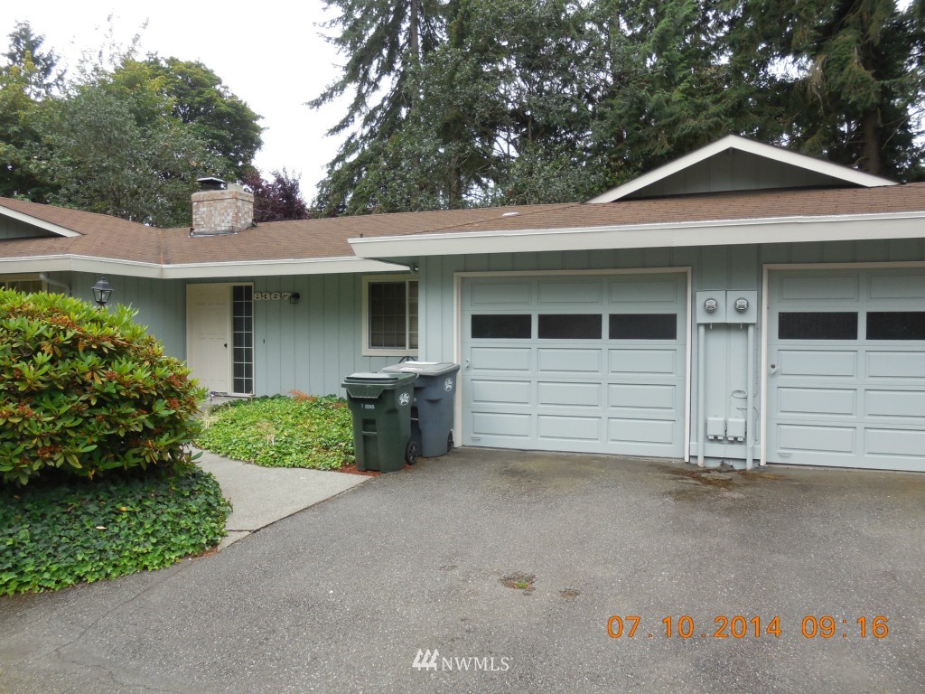 8327 Phillips Road Southwest Lakewood, WA 98498 - Photo 4 of 6 a front view of a house with a garage