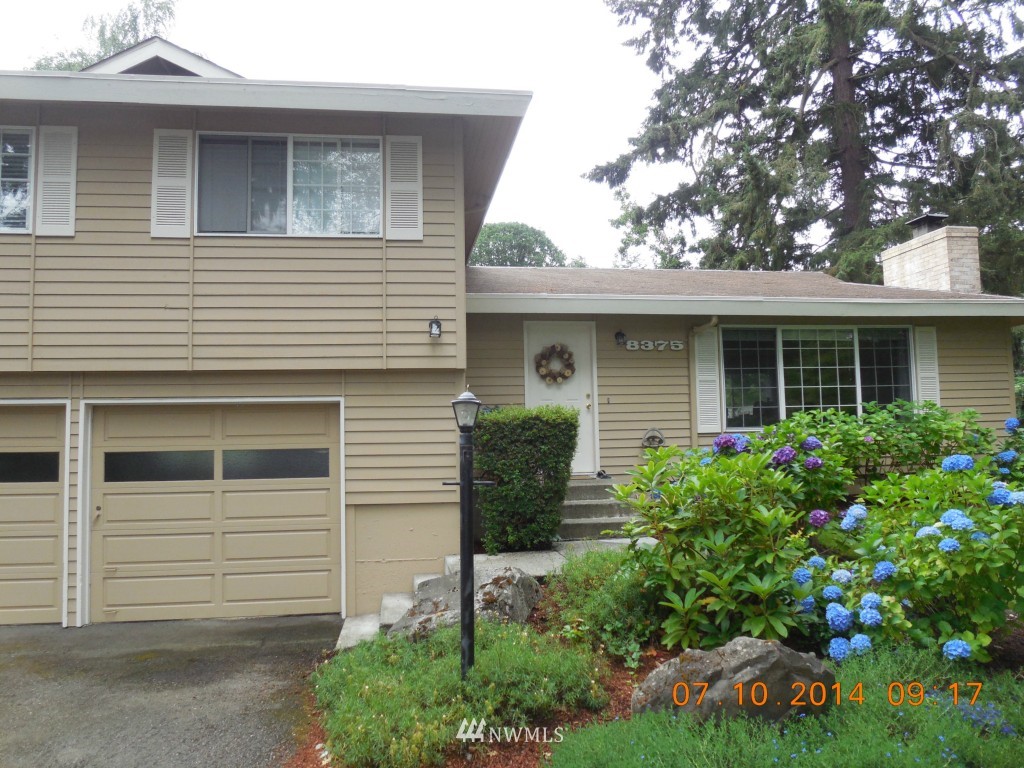 8327 Phillips Road Southwest Lakewood, WA 98498 - Photo 5 of 6 a front view of a house with garden