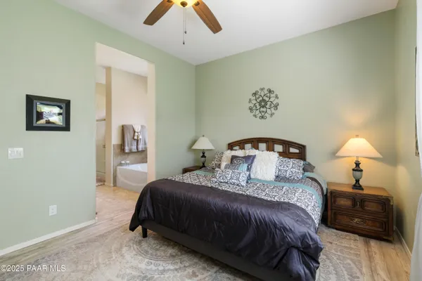 a bedroom with a bed and a lamp