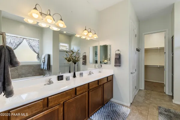 a bathroom with a sink double vanity granite and a mirror