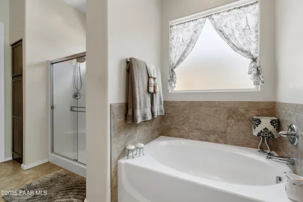 a white bath tub sitting next to a window