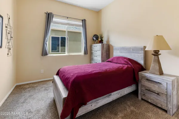 a bed sitting in a bedroom next to a window