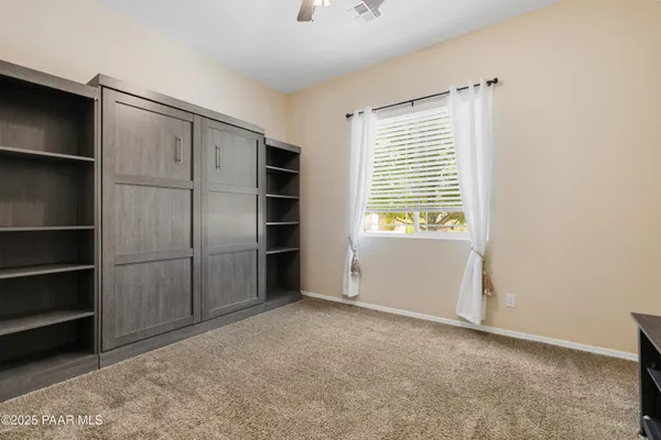 a view of an empty room with a kitchen